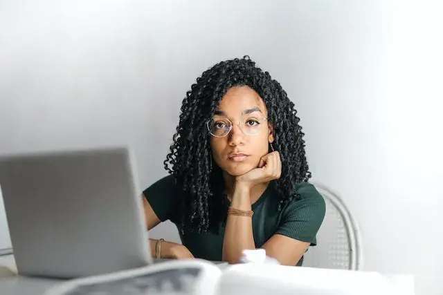 serious-woman-looking-at-camera-in-front-of-pc